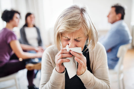 A woman sneezing