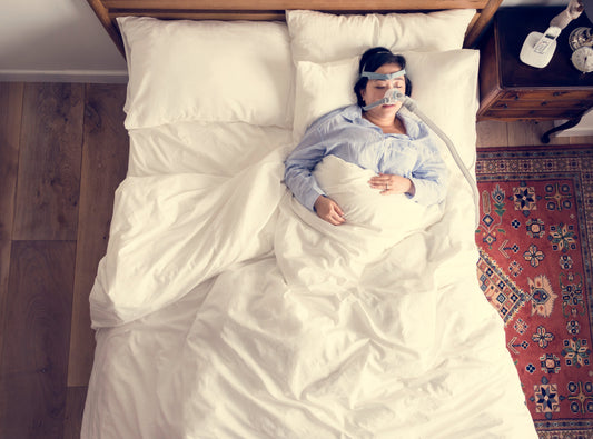A woman sleeping with a CPAP mask